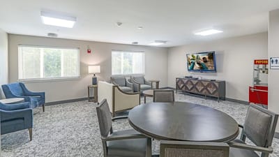 Bright common area with seating and a TV