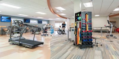 Rehabilitation gym with equipment and staff assisting residents