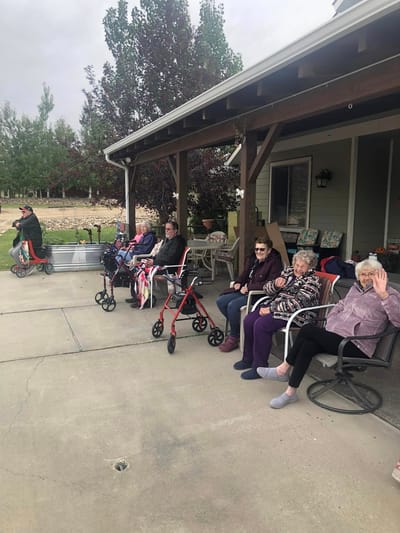 Residents enjoying time outdoors on patio chairs