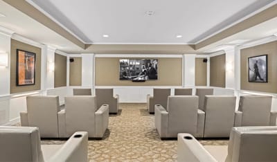 Interior activity room with seating and a large screen