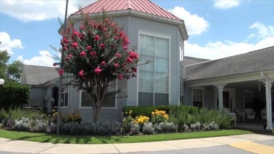 Exterior view of a building with flowers and trees