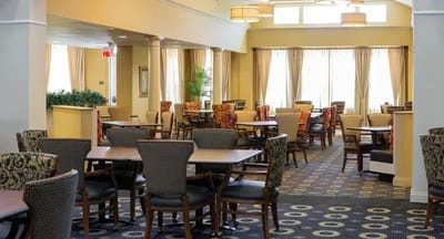Dining area with tables and chairs in a warm setting