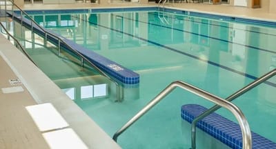 Indoor swimming pool with blue tiled benches