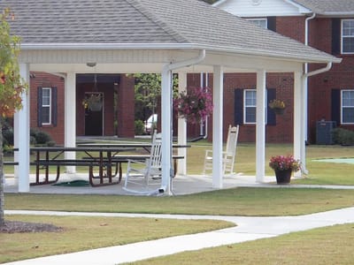 Outdoor gazebo with seating in a landscaped area