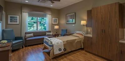 A comfortable private resident room with natural light