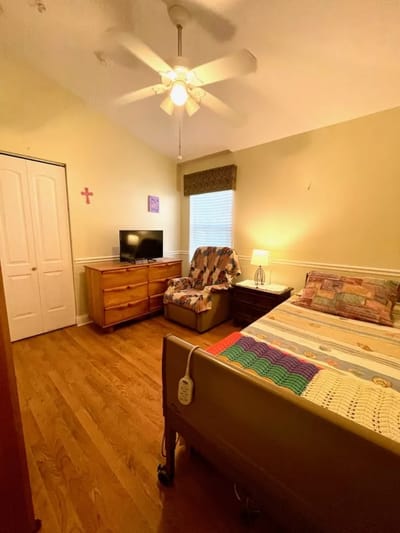 A cozy private resident room with a bed and TV