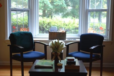 Cozy seating area next to a window with plants outside