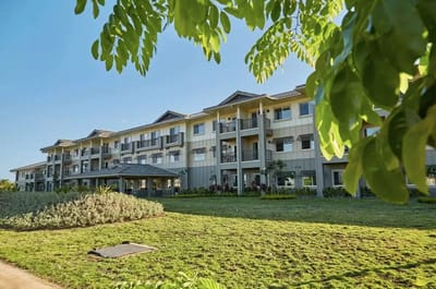 Exterior view of a senior living facility with gardens