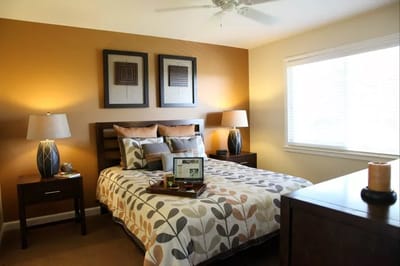 Cozy resident room with decorative bedding and furniture