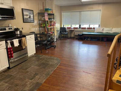 Interior view of a rehabilitation room with kitchen area