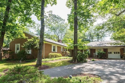 Exterior view of the assisted living facility surrounded by trees