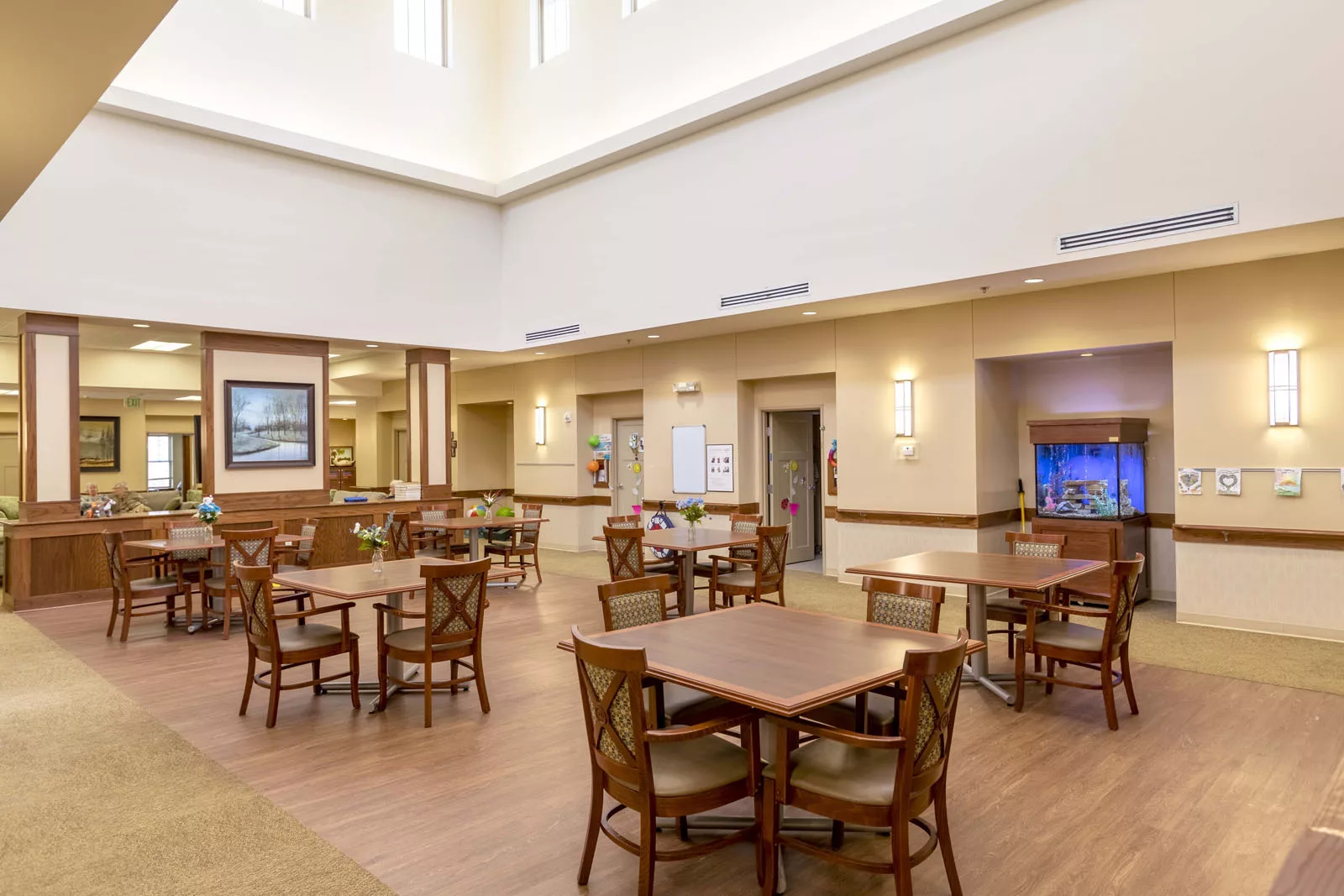 Bright and spacious common area with tables and chairs