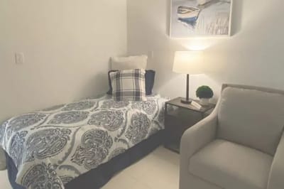Cozy resident room with a bed and a chair