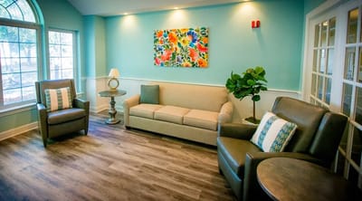 A cozy interior lounge area with seating and artwork