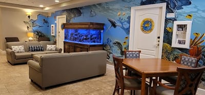 Interior common area with aquarium and ocean mural