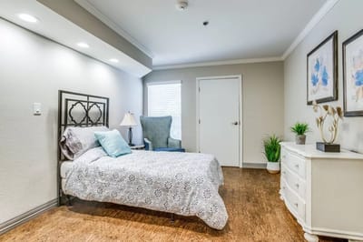 Cozy resident room with bed and armchair