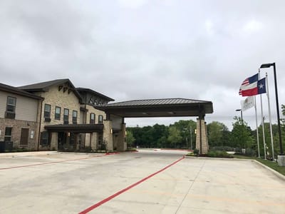 Exterior view of the facility entrance with flags