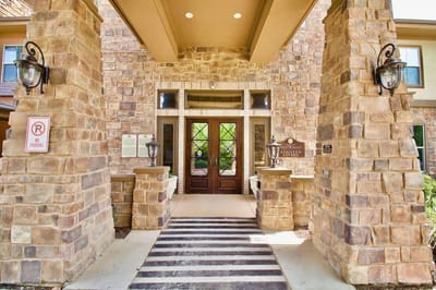 Entrance of the facility with stone pillars and double doors