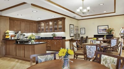 Bright dining area with wooden tables and floral decor