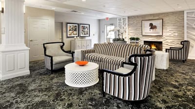 Interior lounge area with striped furniture and fireplace