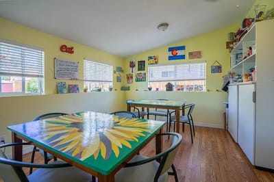 Bright and colorful dining area with tables and art