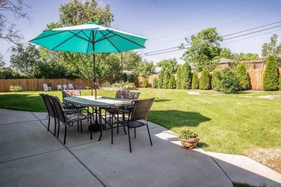Outdoor seating area with umbrellas and lawn