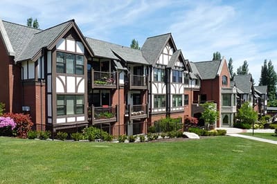 Exterior view of a senior living facility with landscaped grounds