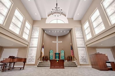 Interior view of a chapel with a cross and seating