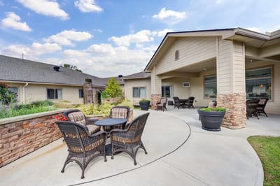 Outdoor patio area with seating and gardens