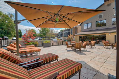 Outdoor seating area with lounge chairs and patio umbrellas