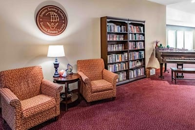 Cozy common area with chairs and bookcase