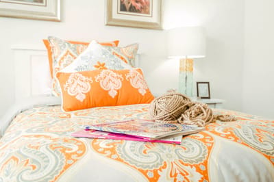 Cozy bedroom with vibrant bedding and decorations