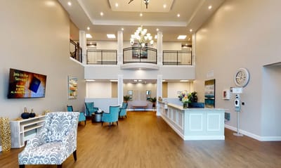 Bright lobby area with seating and a reception desk