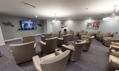 Interior activity room with theater seating and a screen