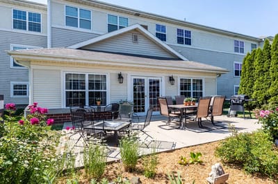 Outdoor patio seating area with flowers and greenery
