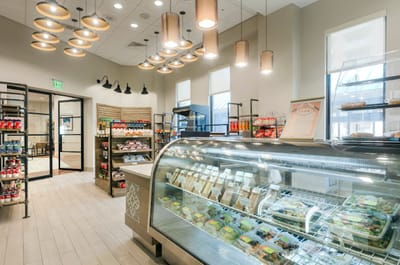 An interior view of a well-lit café with food displays
