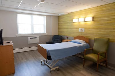 A single resident room with a bed and seating