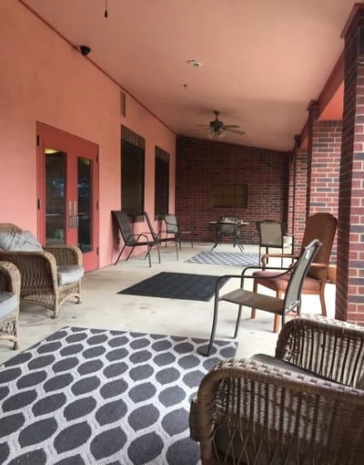Outdoor seating area with chairs and rugs