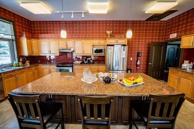 Bright kitchen area with a large granite island