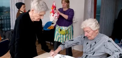 Residents and staff engaged in an arts and crafts activity