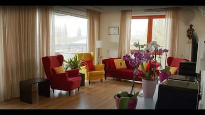 Bright common area with colorful seating and plants