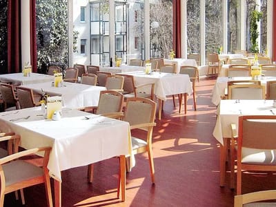 Bright dining room with tables set for meals