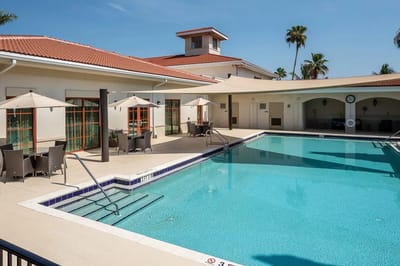 Swimming pool area with seating and umbrellas