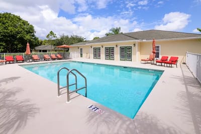 Swimming pool area with lounge chairs and umbrellas