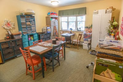 Art and craft activity room with tables and supplies