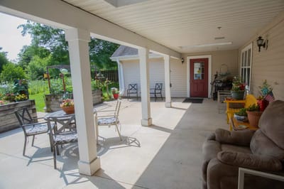 Outdoor seating area with flowers and garden view