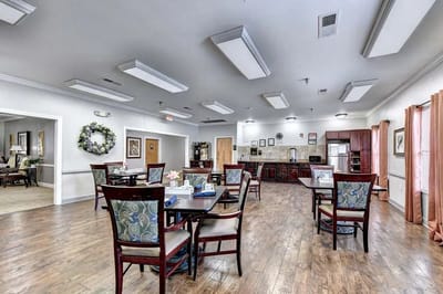 Common area with tables and chairs in a bright setting