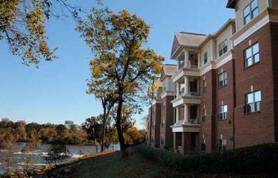 Exterior view of a senior living facility by the river