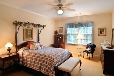 Cozy bedroom with a checkered bedspread and window.