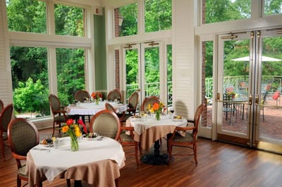 Bright dining room with tables and flowers